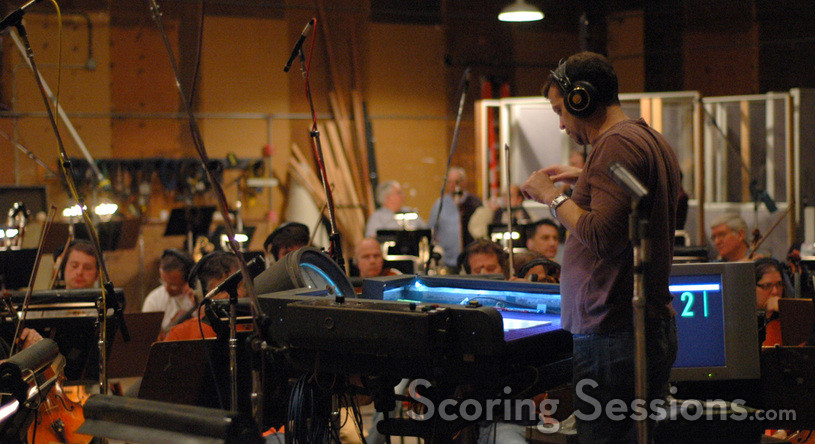 Composer Aaron Zigman conducts the orchestra