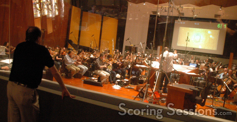 Producer John Davis watches Chris record the music for the new Davis Entertainment Logo