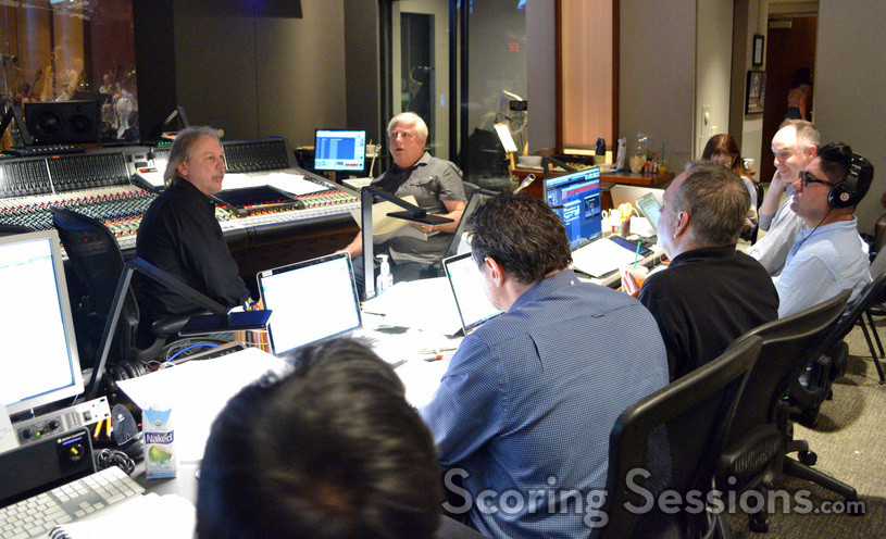 Composer Mark Mancina and orchestrator Dave Metzger talk with the rest of the team