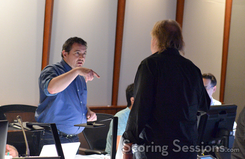 Music production director Andrew Page talks with composer Mark Mancina