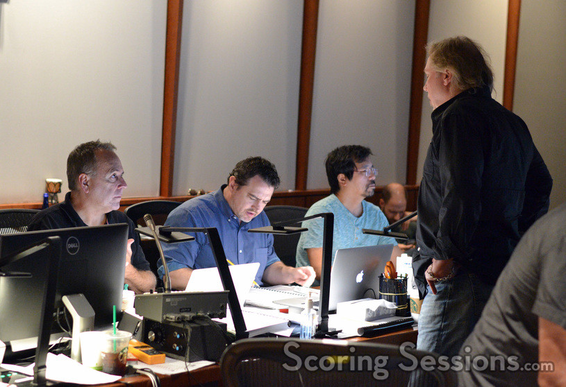 Composer Mark Mancina (standing) talks with music editor Earl Ghaffari, music production director Andrew Page, and ProTools recordist Larry Mah