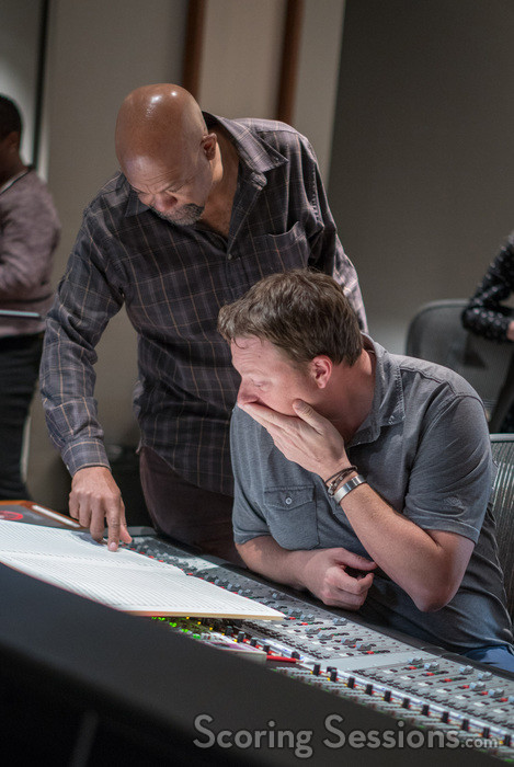 Music librarian Booker White goes over a cue with orchestrator Stephen Coleman