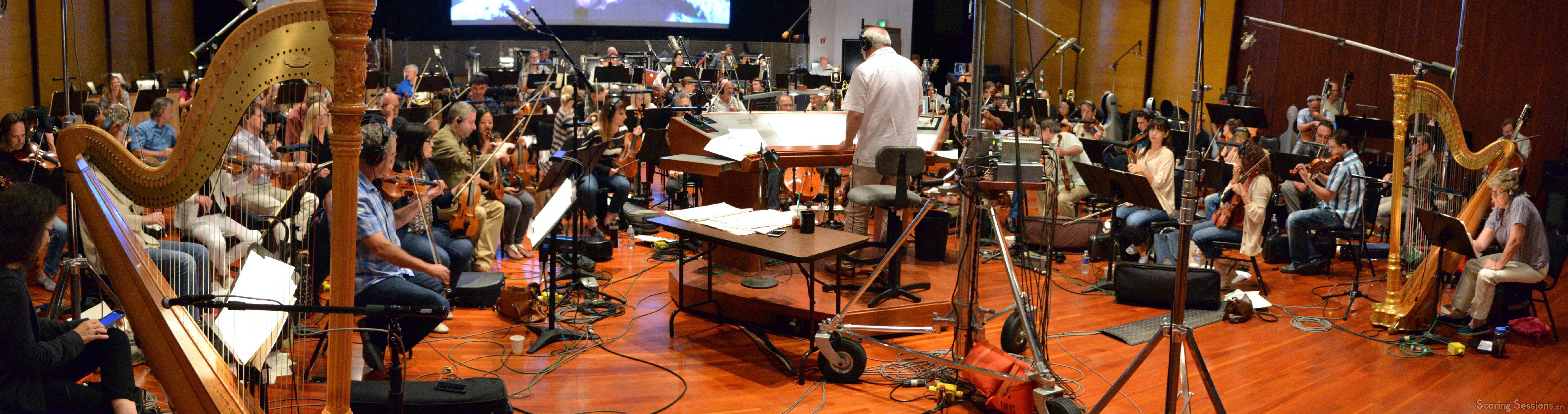 Conductor Don Harper and the orchestra record a cue from composer Mark Mancina's score to Moana